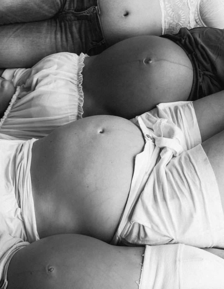 Pregnant women laying in bed together
