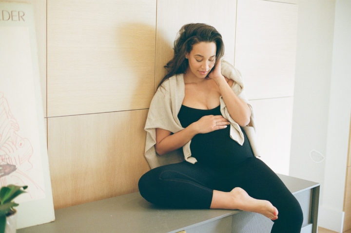 pregnant woman sitting on countertop