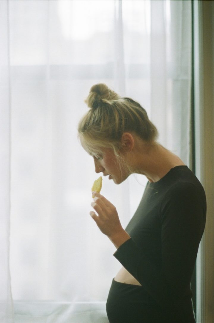 pregnant woman eating mango