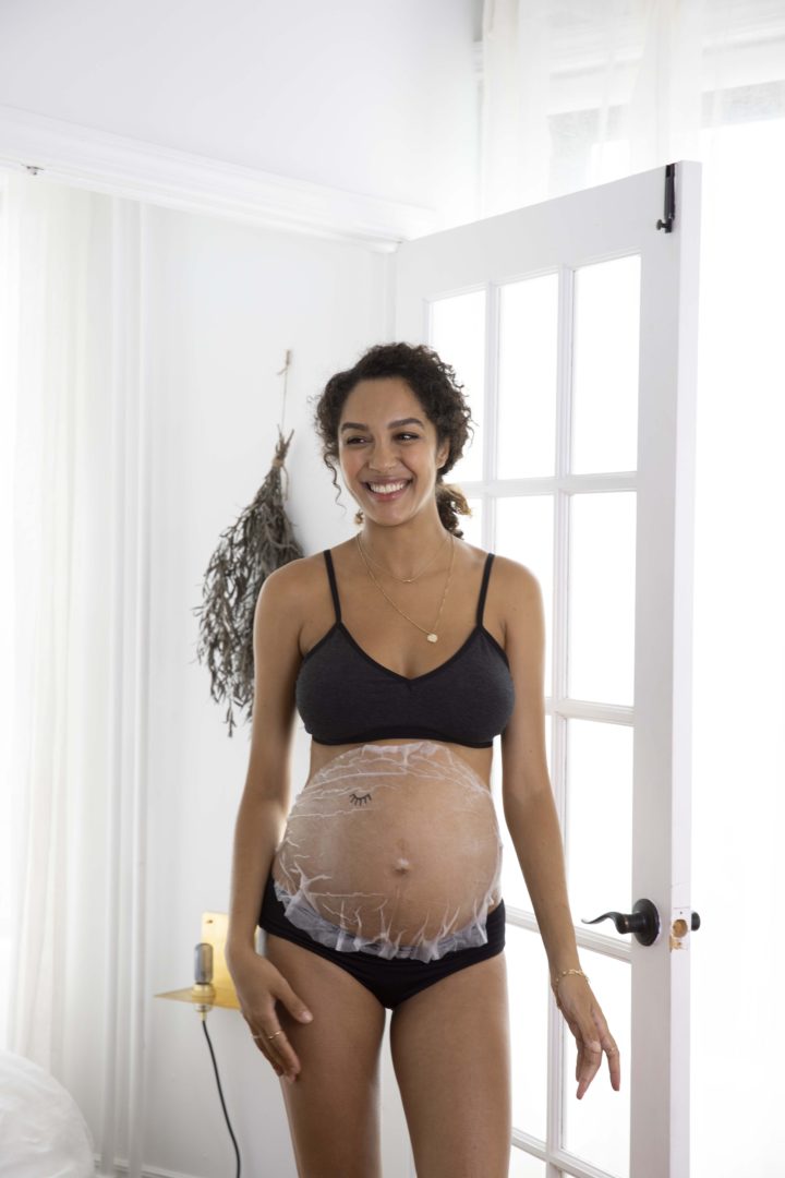pregnant woman wearing a belly sheet mask