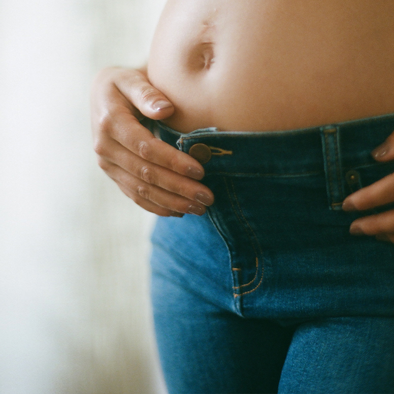 woman's stomach in jeans