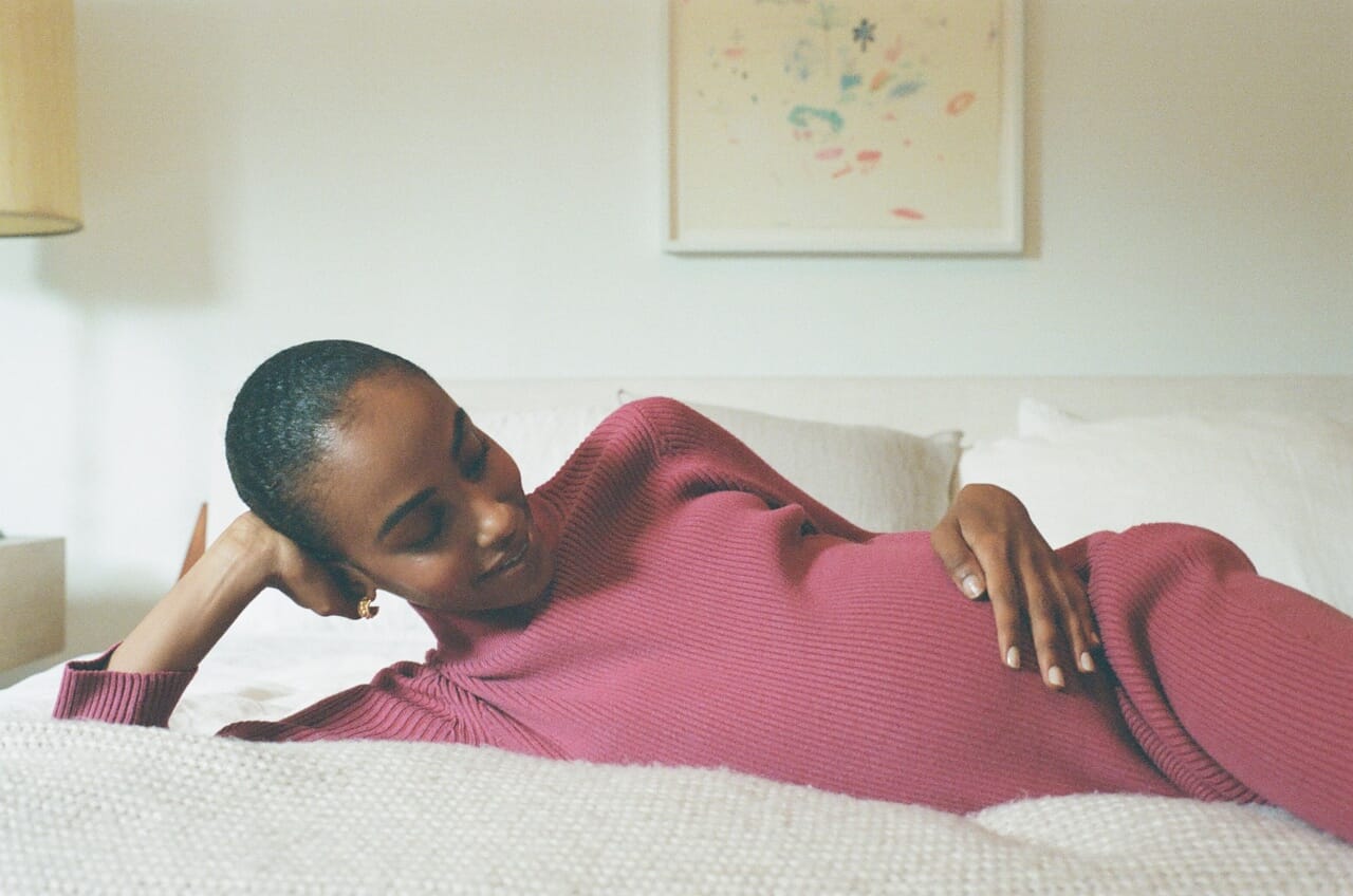 pregnant woman laying on bed