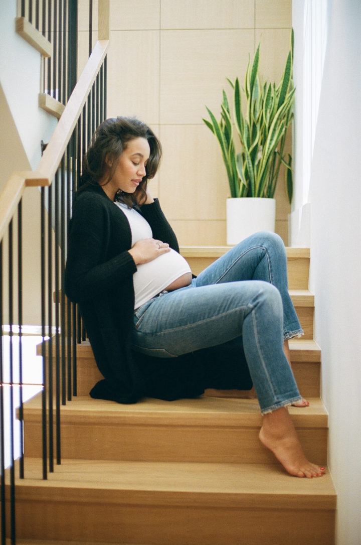 pregnant woman sitting on steps