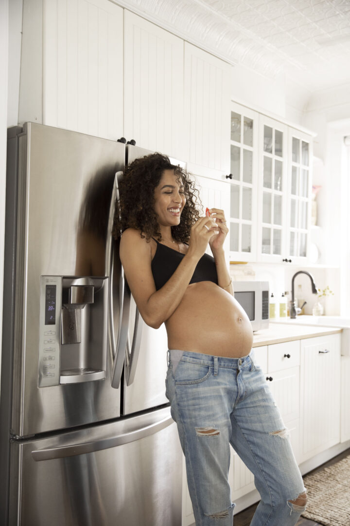 pregnant woman standing in kitchen