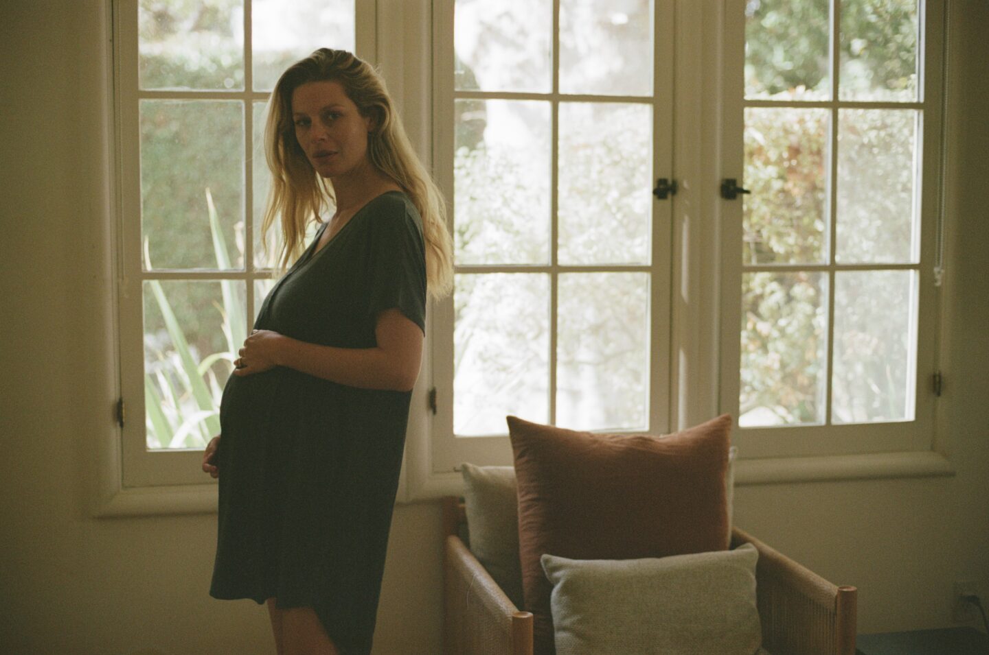 pregnant woman in profile looking at camera