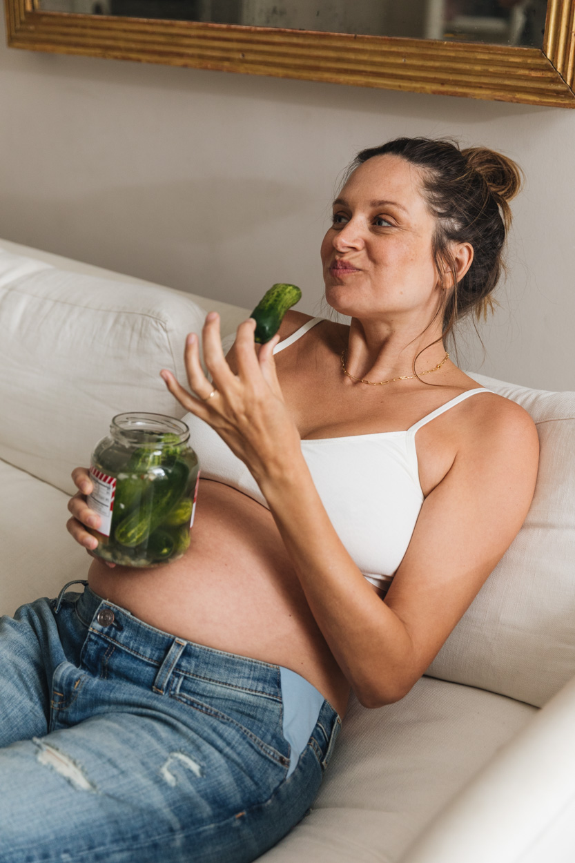 pregnant woman eating a pickle