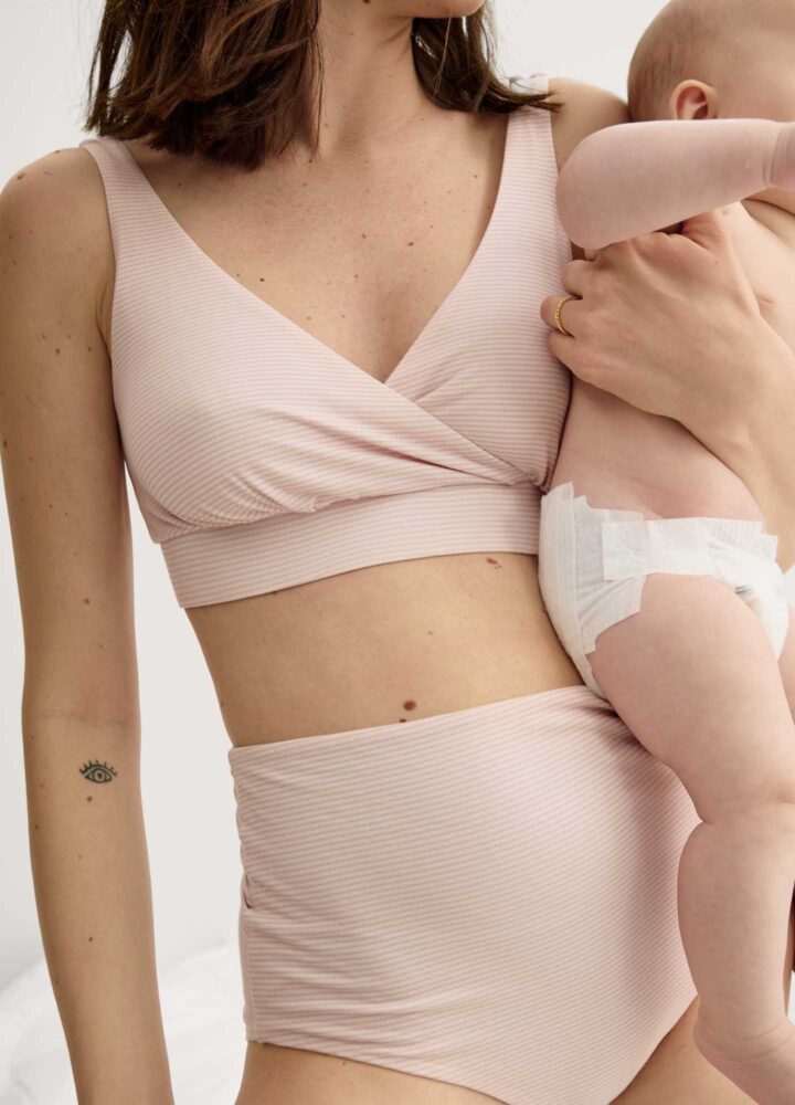 woman in underwear holding baby