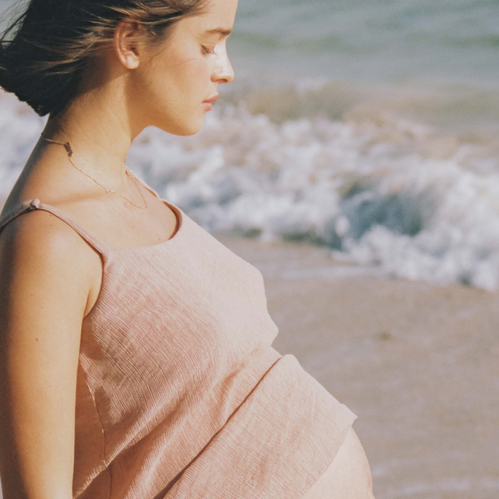 Pregnant woman staring at the ocean