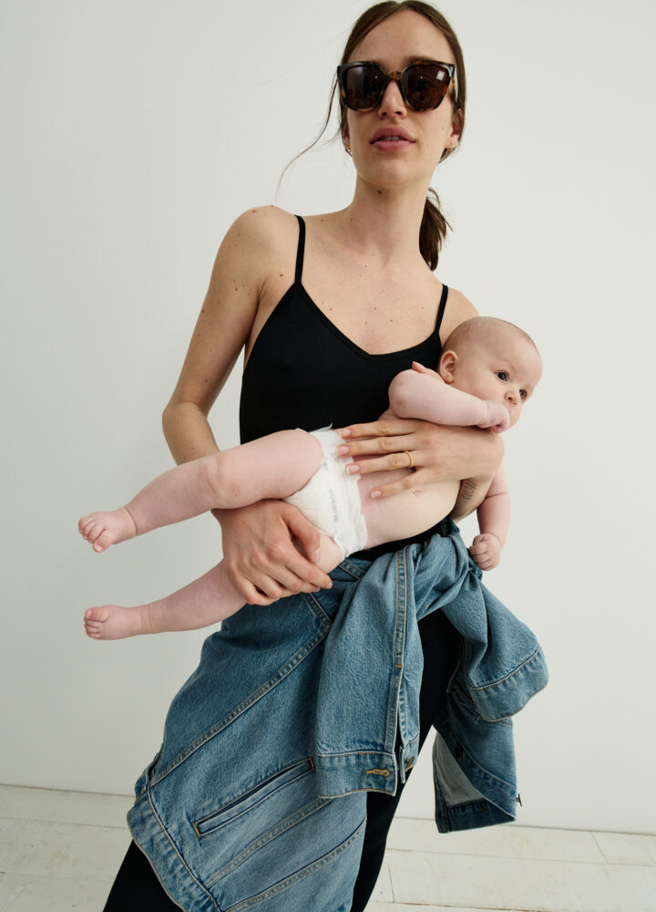 woman in leotard holding baby