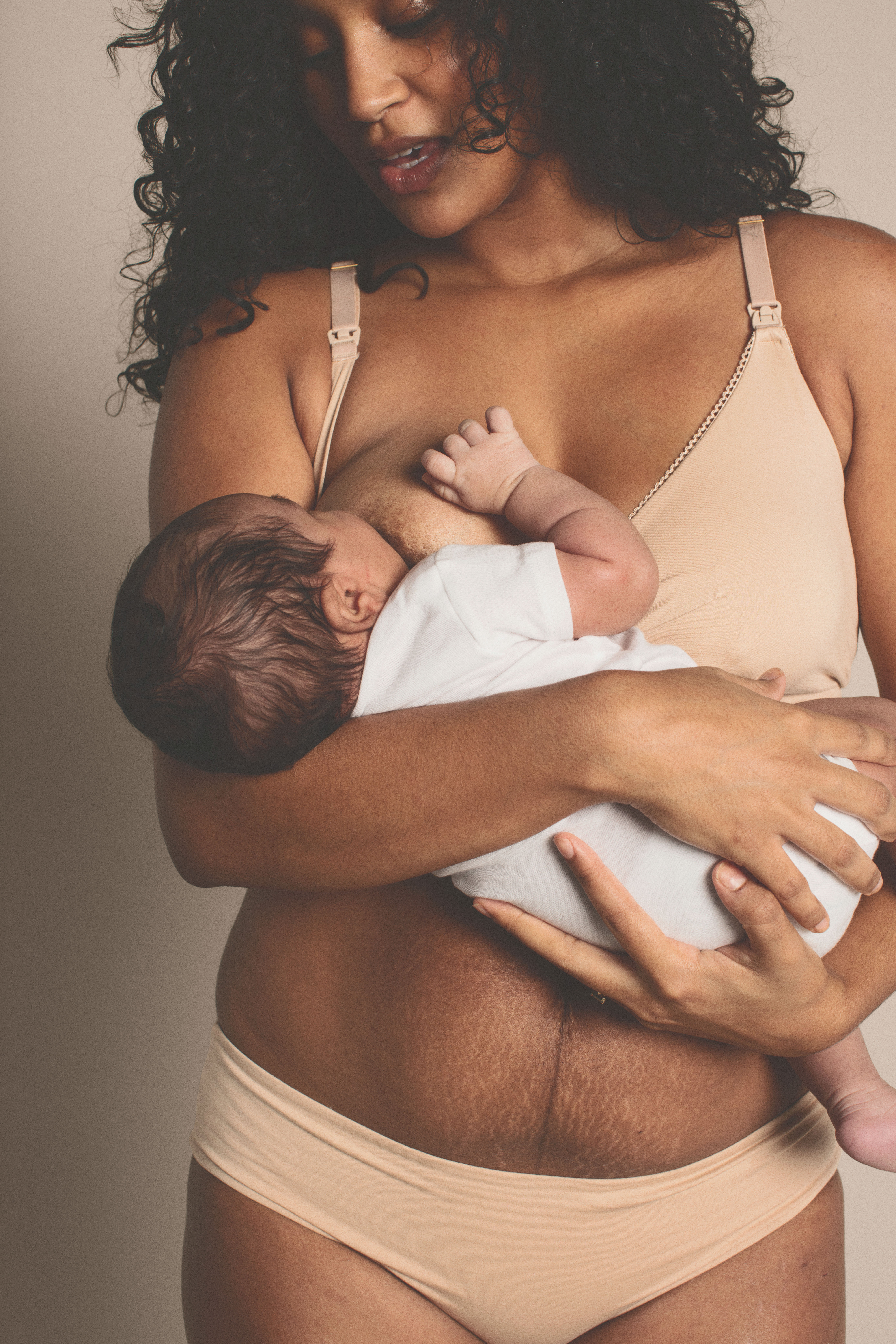 woman in underwear holding a baby